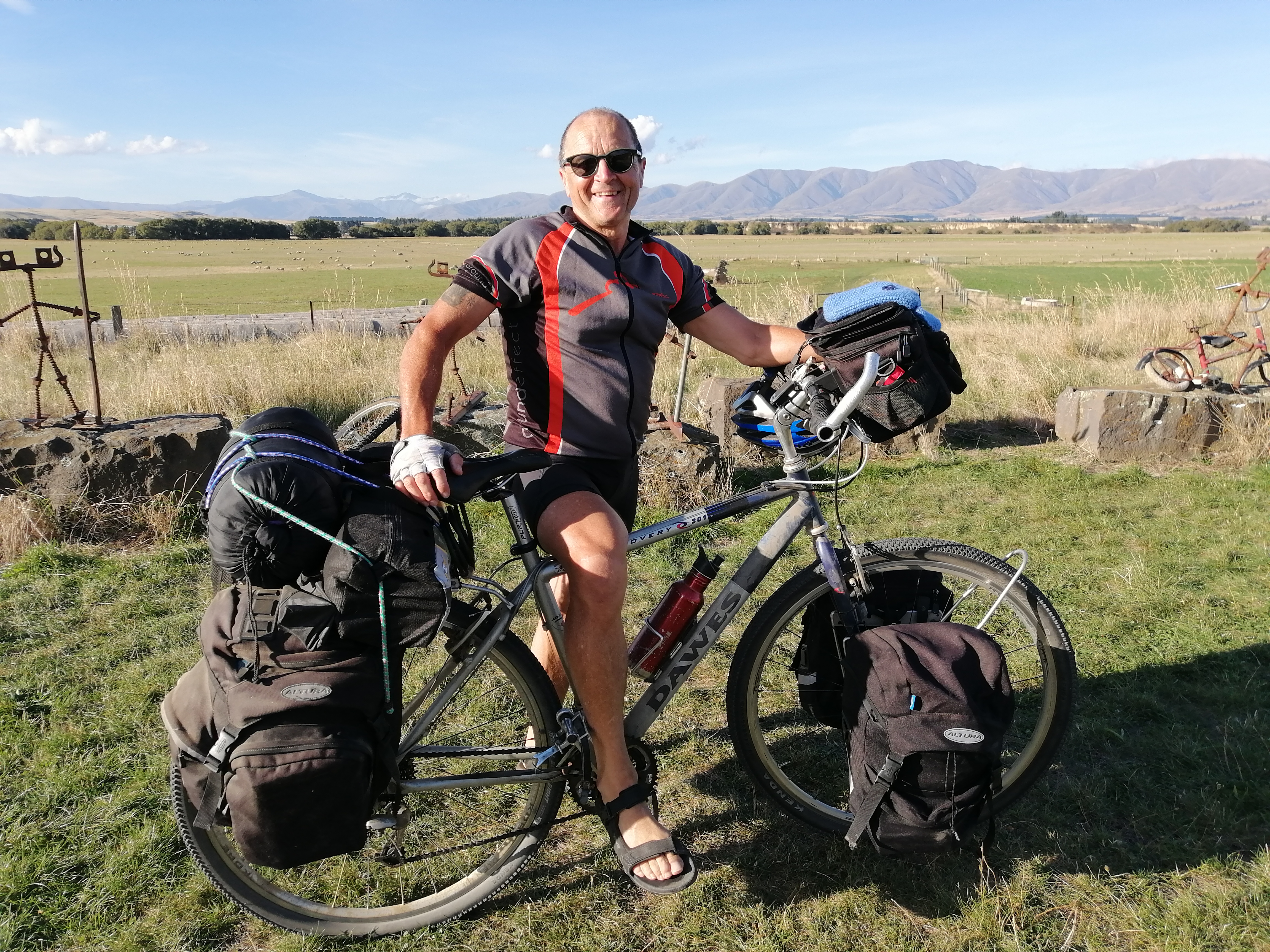 Andy with his bike sporting a plethora of pannier bags pictured on the Otago Rail Trail