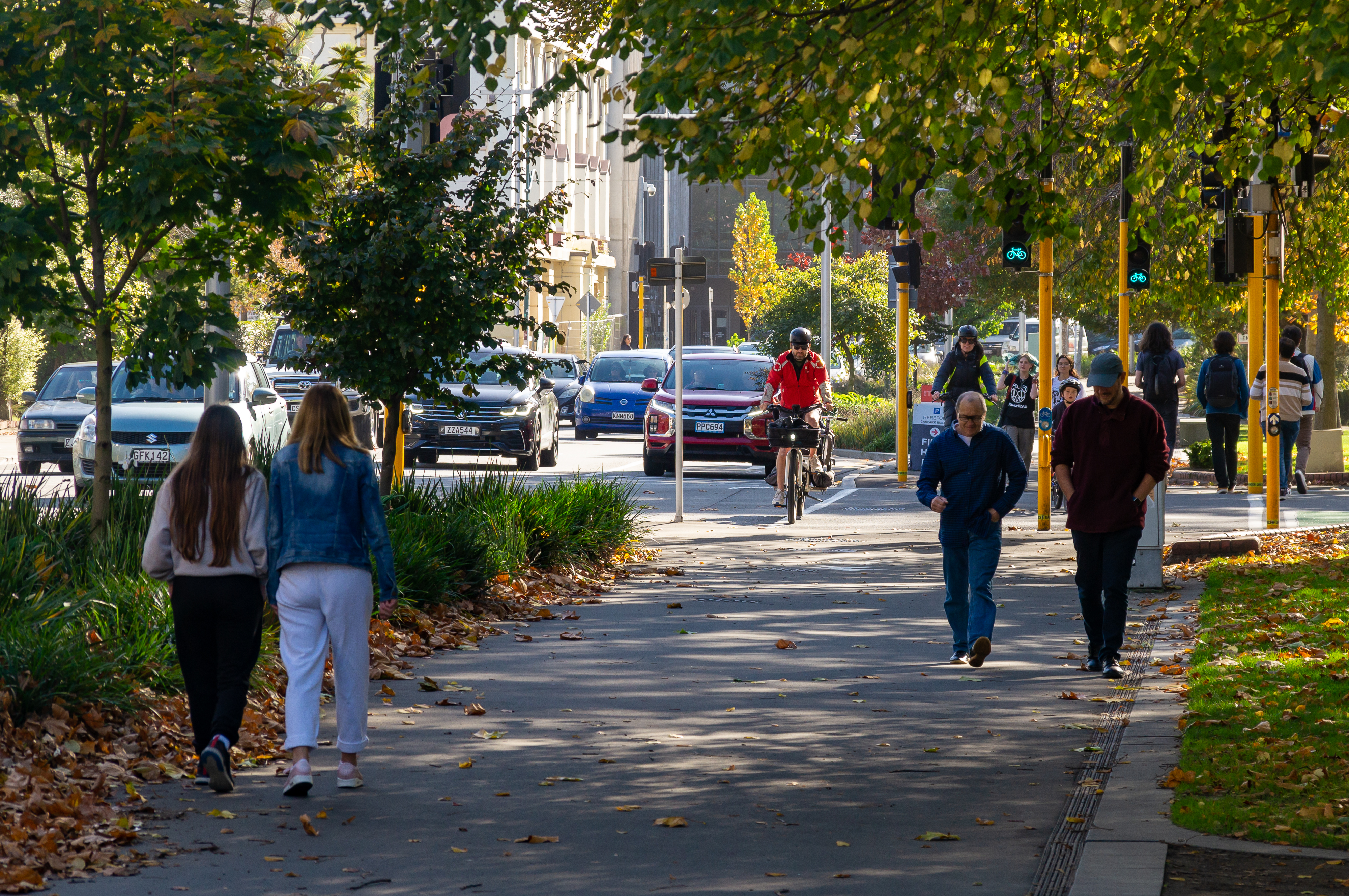 Christchurch street and footpath showing walkers, cyclists and cars on the road