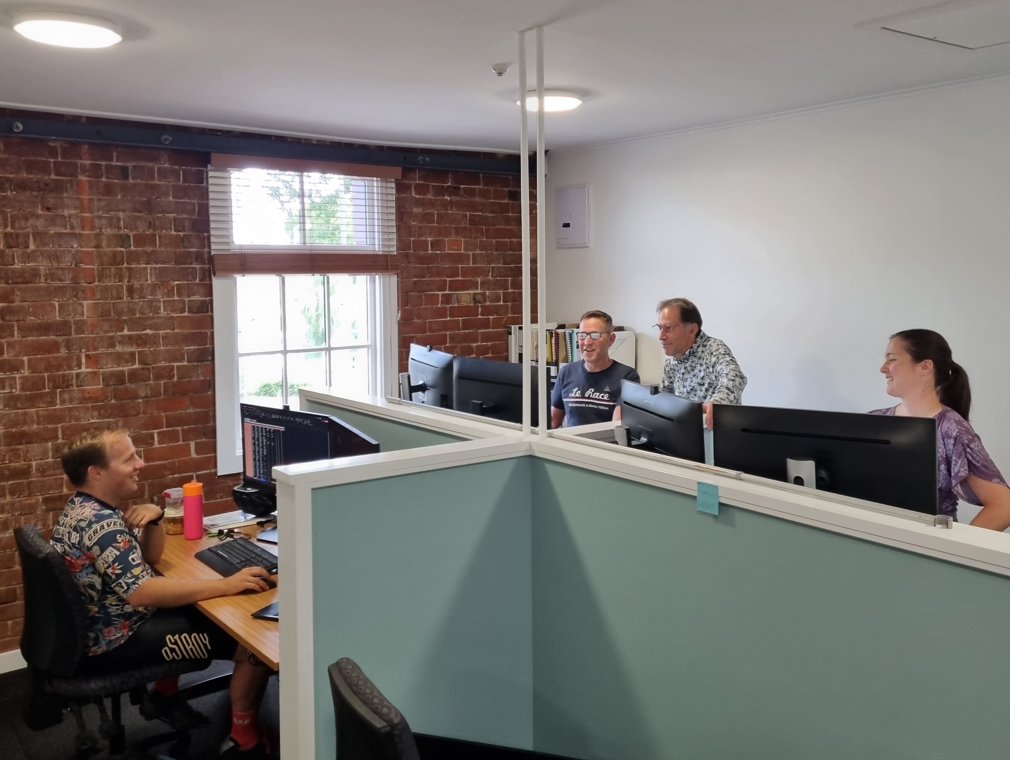 John, Warren, David and Megan all working in the new office space