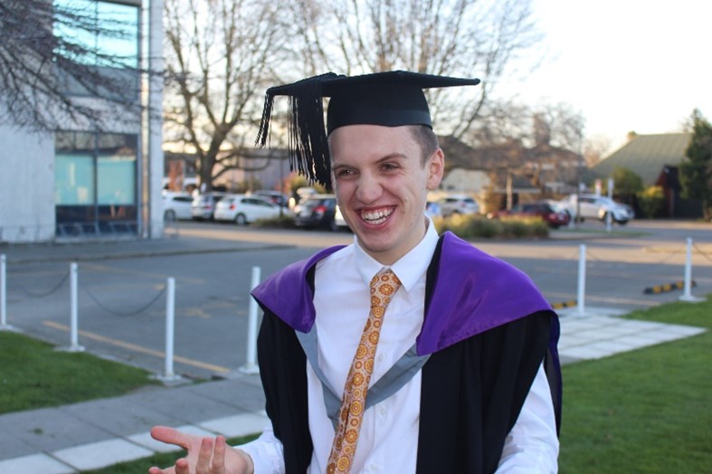 Nick is all smiles in his academic regalia