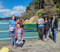 Amy, Debbie, Megan and kids, Glen, Tracey and Mark on the Jetty beside the Quail Island sign on 