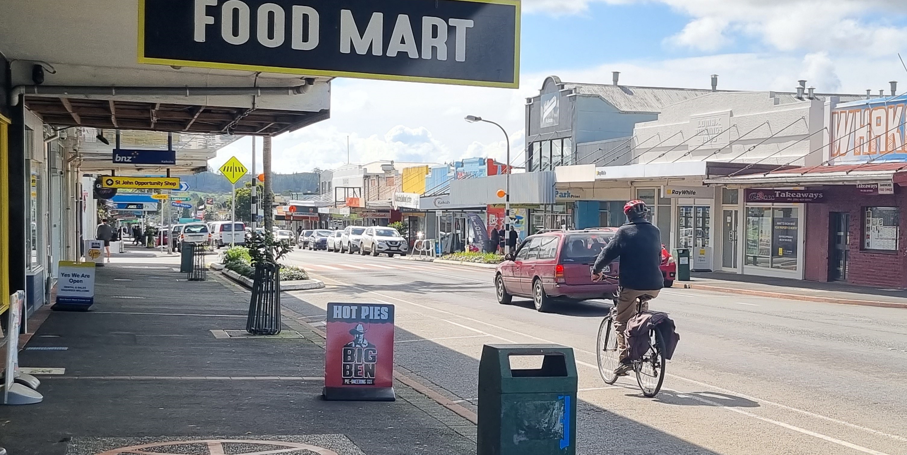 Person riding a bike on main street of Kaikohe, SH1 Broadway, Kaikohe