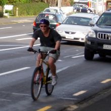 cyclist on road in front of car