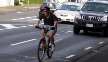 cyclist on road in front of car