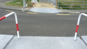 A pathway road crossing with "banana rails" - a type of access restriction devices this is not supported by the auditors or the NZ Transport Agency.