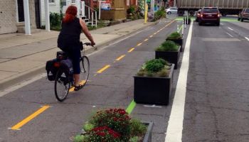 Cycle way separated from road with planter boxes.